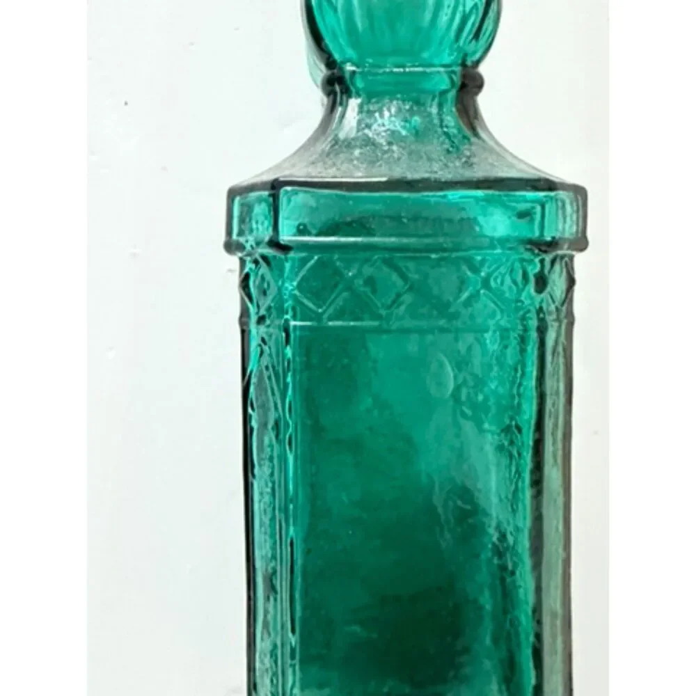 vtg emerald green glass decanter bottle with embossed sides and cork stopper